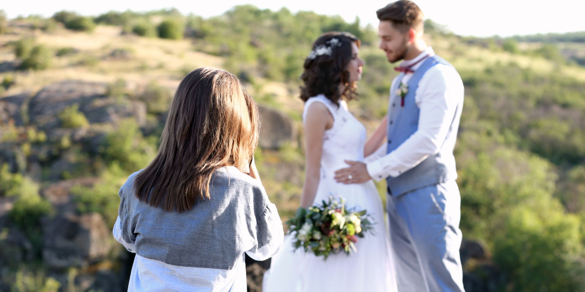 wedding photographer taking bride and groom's photo